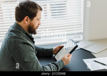 Closeup director using tablet and looking at graphs on screen. Stock Photo