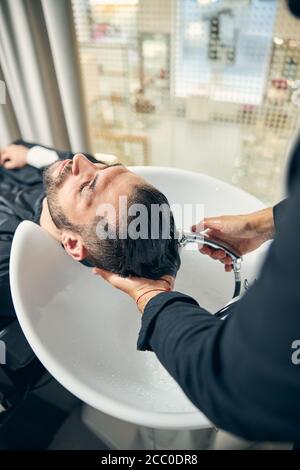 Focused photo on relaxed man being in salon Stock Photo