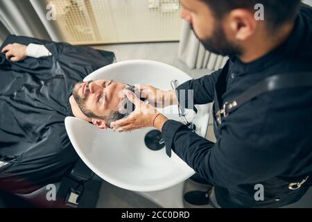 Close up of master washing hair before haircut Stock Photo