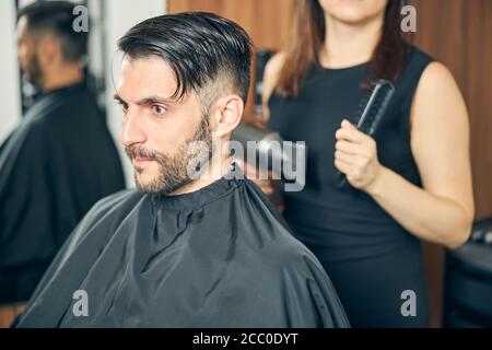 Concentrated young man being deep in his thoughts Stock Photo