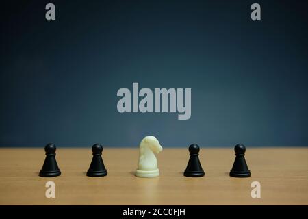 Business strategy conceptual photo - horse knight in the middle of chess piece Stock Photo