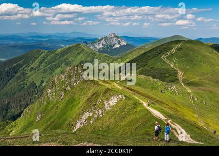 Velky Rozsutec mountain in far distance, Stoh massif on right, hikers, view NE from summit of Chleb, Mala Fatra National Park, Zilina Region, Slovakia