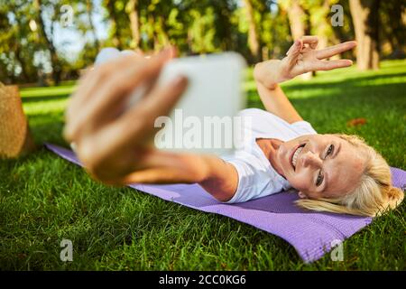 Cheerful woman making selfie on the street Stock Photo