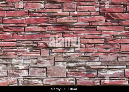 Close up seamless abstract backround of red slate stone wall. Stock Photo