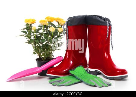 Garden tools with flower pot and boots isolated on white background Stock Photo