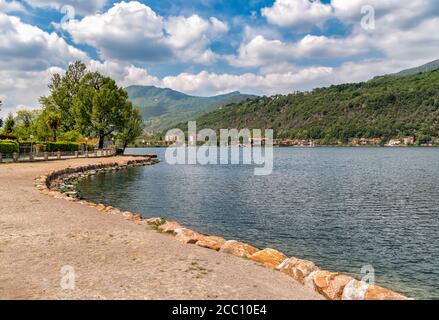 Landscape of lake Lugano on a cloudy day, Porto Ceresio Tresa, Italy Stock Photo