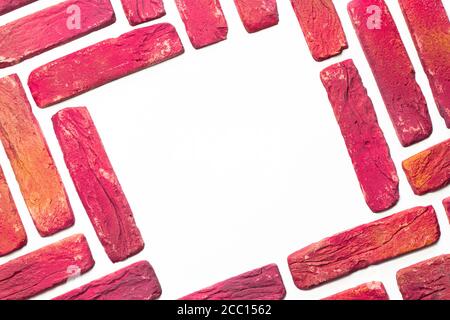 Bright bricks on white backdrop. Abstract background. Stock Photo