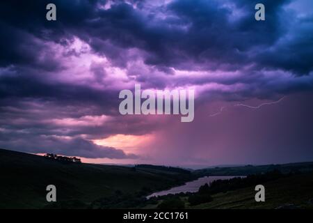 The colors of the storm with thunderbolts on night sky in Brecon Beacons National Park in Wales. Stock Photo