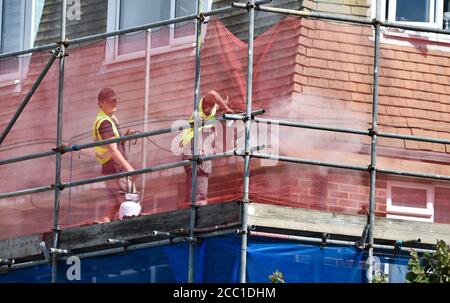 Hove UK 17th August 2020 - Builders add a noisy distraction during the 3rd day of the Bob Willis Trophy cricket match between Sussex and Essex taking place behind closed doors with no fans attending at The 1st Central County Ground in Hove : Credit Simon Dack / Alamy Live News Stock Photo