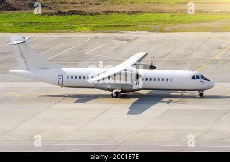 Passenger turboprop airplane taxi for takeoff at the airport Stock Photo