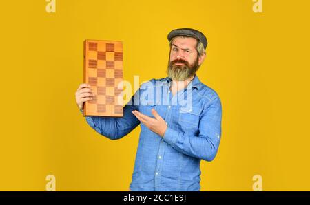Teacher chess competition. Board game. Bearded man playing chess. Chess figures. Intellectual games. Game strategy concept. Chess lesson. Grandmaster experienced player. Cognitive development. Stock Photo