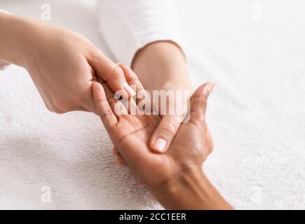 Top view of african woman getting hand massage at spa Stock Photo