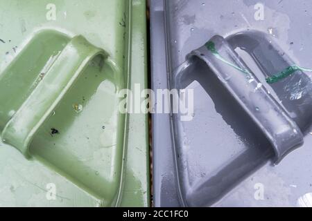 Top down view of a household waste bins used by a typical household. Seen after a heavy downpour. Stock Photo