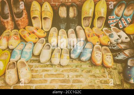 Retro styled image of different colorful vintage Dutch wooden clogs Stock Photo