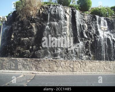 View from Road of Natural Spring Waterfall on side of mountain in Saudi Arabia Stock Photo