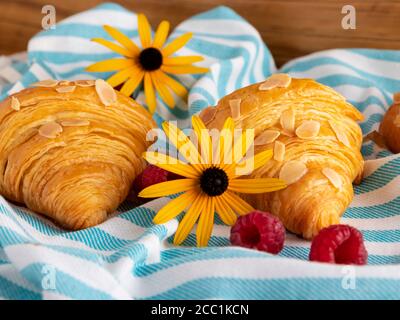 Yummy freshly two croissants with raspberries, close up Stock Photo