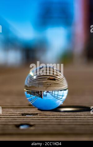 Vertical shot of a bridge through a glass ball Stock Photo