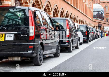 A row of waiting London taxi cabs outside St Pancras Internation Station on Midland Road, London, UK Stock Photo