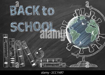 Back to School lettering, books and globe in shape of coronavirus  are drawn with chalk on a blackboard. Covid-19 concept. Start of the new school yea Stock Photo