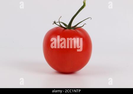 Isolated closeup shot of a cherry tomato Stock Photo