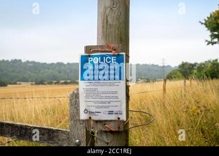 Police sign at the entrance to a field warning dog walkers to keep dogs on leads. Stock Photo