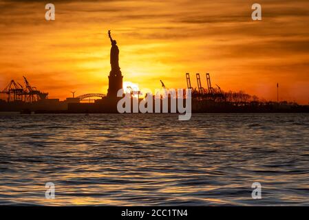 Fiery Red Sunset Behind The Statue Of Liberty Silhouette New York City Stock Photo