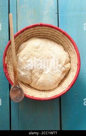 Bowl of white bread dough on table, close up Stock Photo