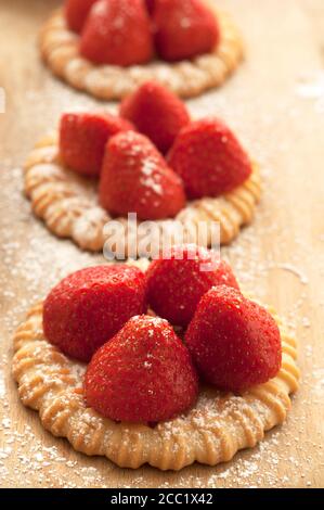 Strawberry tartlet on chopping board, close up Stock Photo