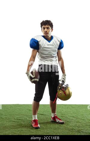 Confident posing. American football player isolated on white studio background with copyspace. Professional sportsman during game playing in action and motion. Concept of sport, movement, achievements. Stock Photo