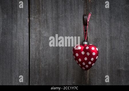 Heart shaped Christmas bauble hanging on door Stock Photo