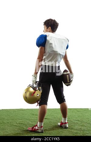 Confident posing. American football player isolated on white studio background with copyspace. Professional sportsman during game playing in action and motion. Concept of sport, movement, achievements. Stock Photo