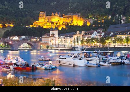 Germany, Heidelberg, People in boat on Neckar River with castle in background Stock Photo