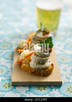 Fingerfood with slices of baguette and german Weißwurst, close-up Stock Photo