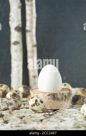 Easter egg in egg cup with Quail eggs Stock Photo