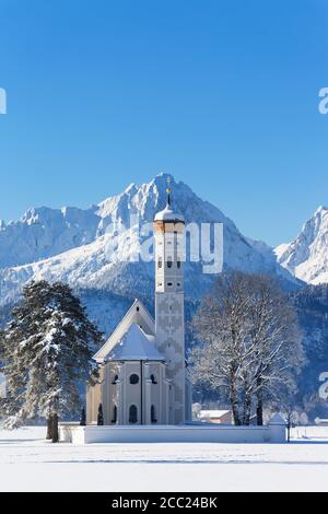 Germany, Bavaria, View of St Coloman Church in front of Tannheim Mountains Stock Photo