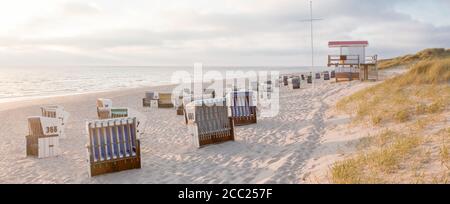 Germany, View of empty beach with roofed wicker beach chairs on Sylt island Stock Photo