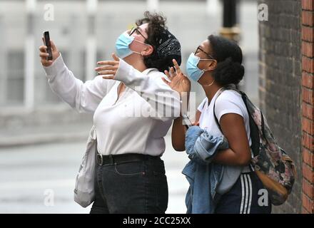 Students Freya Johnson (right) and Zeynep Okur outside the Department for Education building in London, reacting to news of the U-turn on the system for awarding A-level and GCSE grades. A-level and GCSE results in England will now be based on teachers??? assessments of their students, unless the grades produced by the controversial algorithm are higher, regulator Ofqual announced this afternoon. Stock Photo