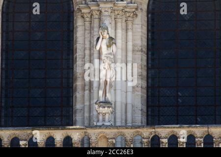 Adam - balustrade of West facade of Notre-Dame de Paris - Statue added added by E. Viollet-le-Duc during the 19th century restoration of the Cathedral Stock Photo