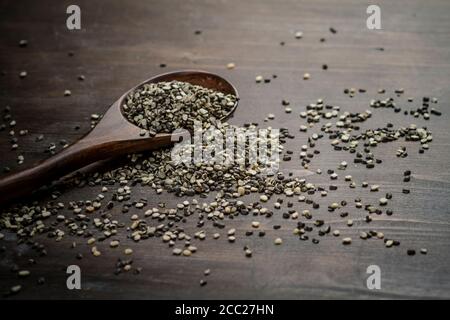 Black and white split urad dhal lentils on a wooden spoon, close up Stock Photo