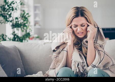 Photo of beautiful suffering house wife lady stay home quarantine covered checkered blanket hold temples fingers coronavirus infection flu cold Stock Photo