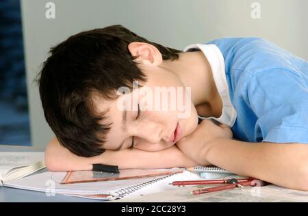 Boy tired from doing his homework Stock Photo