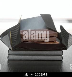 Stack of chocolate squares close up Stock Photo - Alamy