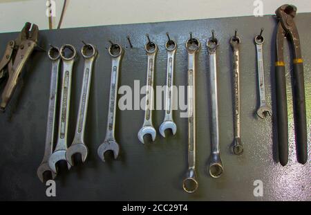 auto mechanical tool on a wooden panel hung on the wall Stock Photo