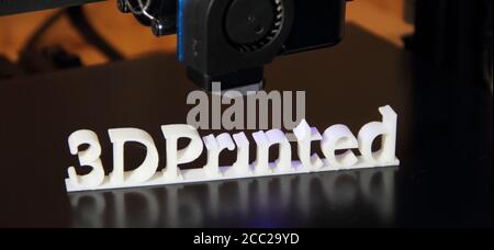 a 3D printer printing the text "3d printed" Stock Photo