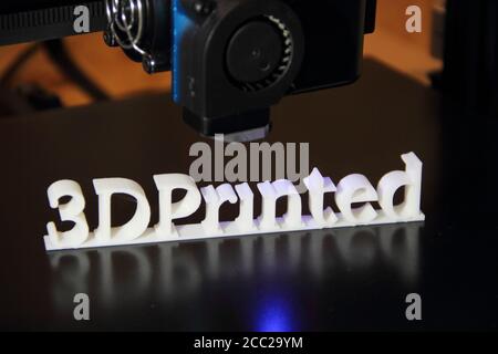 a 3D printer printing the text "3d printed" Stock Photo
