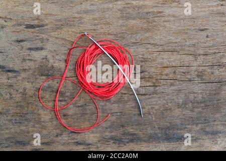 Leather craft tools on a old wood backgrounde. Craftsman work desk . Piece of hide and working handmade tools on a work table. Stock Photo