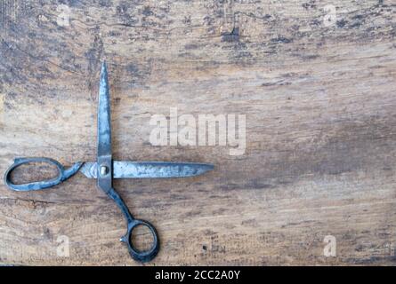 Leather tool for craftsmans. Professional scissors on the wooden backgrounde. Stock Photo