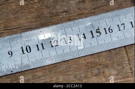 Leather craft tools on a old wood backgrounde. Craftsman work desk . Piece of hide and working handmade tools on a work table. Stock Photo