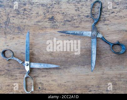 Leather tool for craftsmans. Professional scissors on the wooden backgrounde. Stock Photo