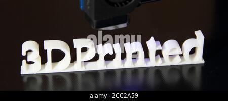 a 3D printer printing the text "3d printed" Stock Photo